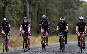 Five men ride side by side on bikes for Condev Cares charity