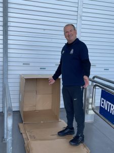 Colin Wheeler stands next to cardboard sleeping spot at Vinnies CEO Sleepout 2021