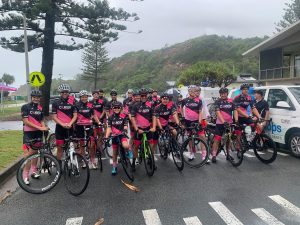 Alan Thompson and group of riders stand with bikes in road for Condev Cares Life Cycle 2021