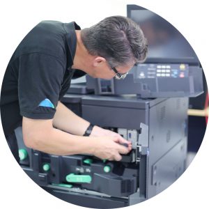 Document Solutions technician fixing inside Konica Minolta production press machine