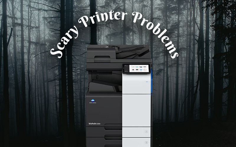 Konica Minolta copier in a spooky forest with text: scary printer problems