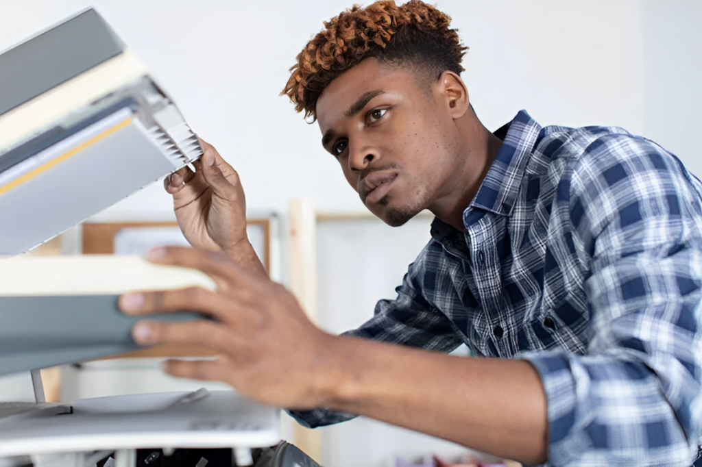 Printer Troubleshooting - Man fixing a copier